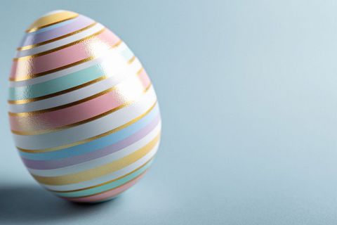 Colorful Striped Easter Egg Against Pastel Background