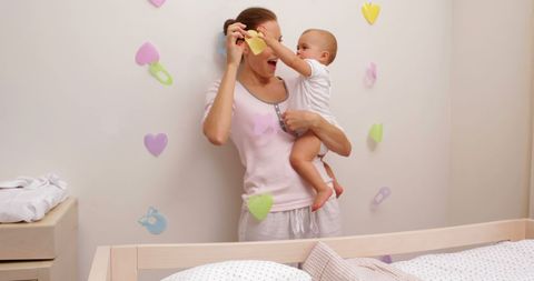 Mother and Baby Bonding in Child's Bedroom