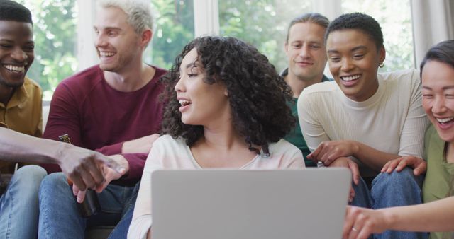 Diverse group of friends enjoying time together using a laptop - Download Free Stock Images Pikwizard.com