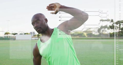 Athlete stretching with futuristic hud overlay on green sports field wearing neon top