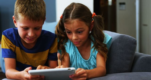 Children Using Tablet Together on Sofa, Learning and Playing - Download Free Stock Images Pikwizard.com