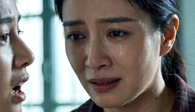 Tearful asian woman crying close-up showing tear tracks, intimate emotional confrontation