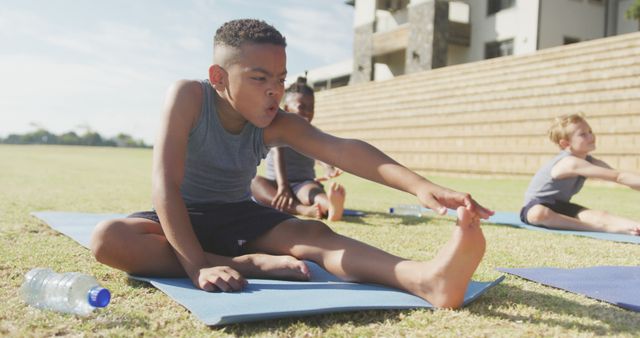 Image of focused diverse boys practicing yoga on mats on sunny day - Download Free Stock Photos Pikwizard.com