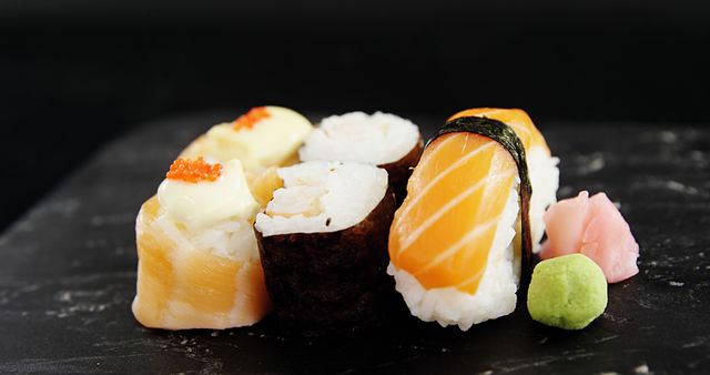 Close-up of Assorted Sushi Pieces on Black Slate - Download Free Stock Images Pikwizard.com