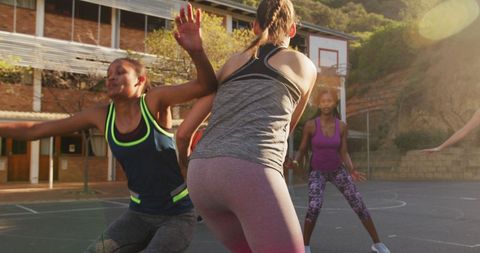 Diverse Female Basketball Team Playing at Outdoor Urban Court