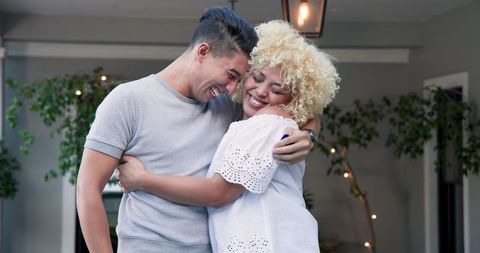 Happy couple embracing contrast celebrating surprise moment
