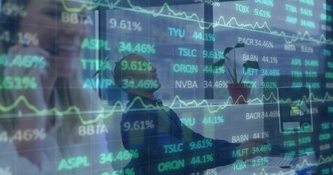 Trader Leaning Back Monitoring Financial Data and Market Tickers with Teamwork in Office