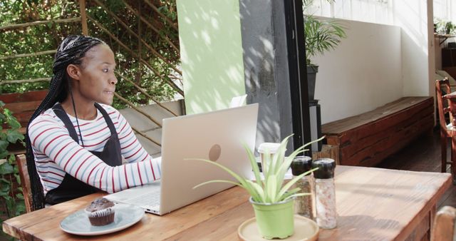 African American Woman Working on Laptop in Modern Cafe - Download Free Stock Images Pikwizard.com