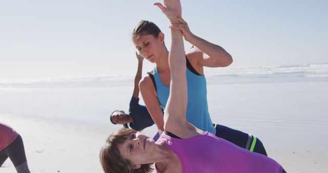 Yoga Instructor Helping Woman with Triangle Pose on Beach - Download Free Stock Images Pikwizard.com