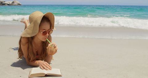 Relaxed Woman on Beach Reading Book with Coconut - Download Free Stock Images Pikwizard.com