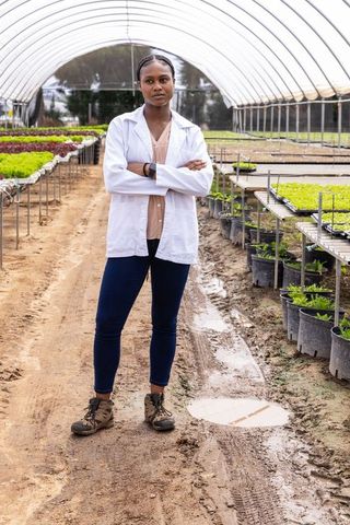 Female botanist in greenhouse lab innovating horticultural research