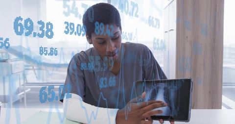 African american female doctor analyzing data on tablet with digital interface