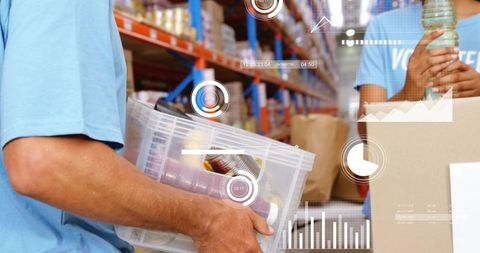 Volunteers packing food donations in warehouse using digital inventory hud and analytics