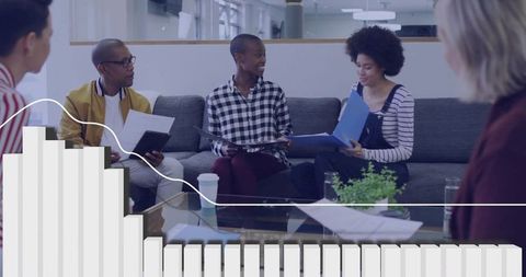 Diverse team collaborating on documents in modern office lounge with data overlay