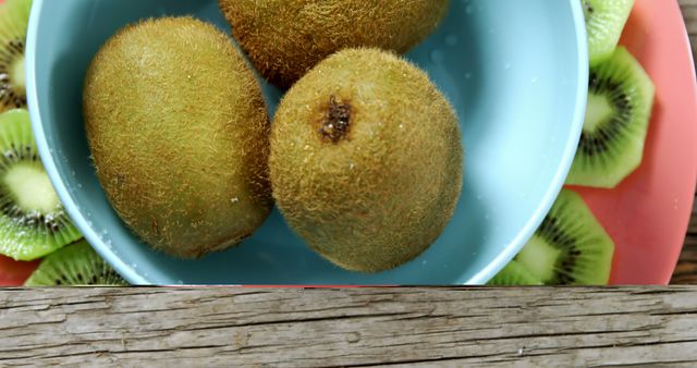 Fresh Kiwis in Bowl on Wooden Table - Download Free Stock Images Pikwizard.com