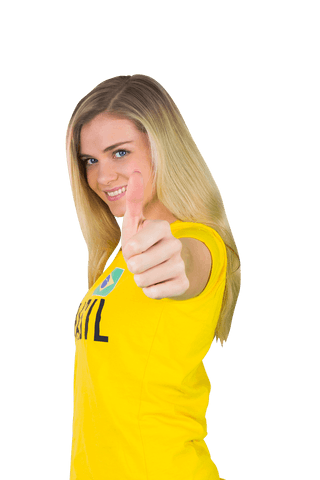 Smiling football fan with thumbs up wearing transparent brazil t-shirt