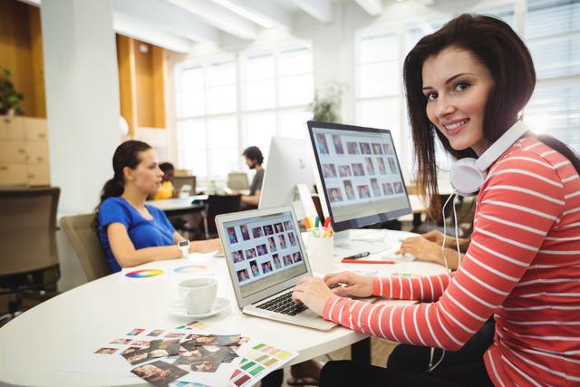 Graphic Designer Working on Laptop in Modern Office - Download Free Stock Images Pikwizard.com