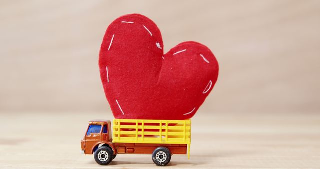 Small toy truck with large red heart represents love, care, and affection suitable for Valentine’s Day themes, children's play concepts, or expressing love and care. Ideal for use in advertising, greeting cards, children's books, and romantic messages.