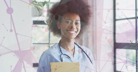 Smiling black clinician with stethoscope and clipboard showing network health analytics