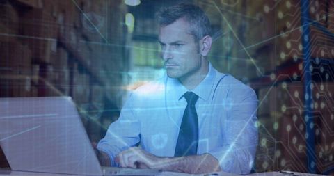 Businessman analyzing data in high-tech warehouse environment