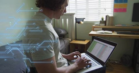 Typing man working on laptop in minimalist bedroom workspace with digital circuit overlay