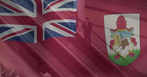 Businessmen using technology while being highlighted by bermuda flag overlay
