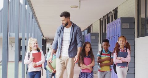 Teacher Guiding Diverse Group of Children at School