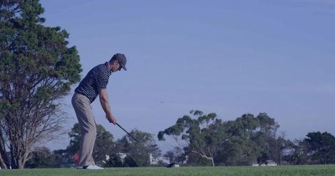 Golfer Aligning Precision Shot on Scenic Golf Course Tee
