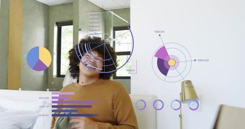 Smiling man in brown sweater holding cloth interacting with augmented reality hud in bedroom