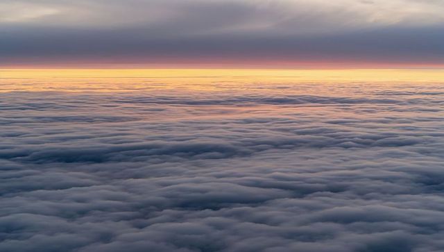 Soothing cloudscape at sunrise with soft pastel hues