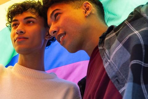 Two Young Men Celebrating Pride with Rainbow Flag