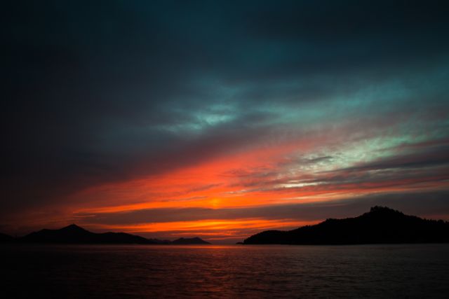 Stunning Sunset Over Serene Mountainous Sea - Download Free Stock Photos Pikwizard.com