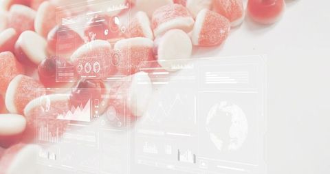 Red and white gummy candies showcasing futuristic hud dashboards on minimal white surface
