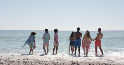 Group of Diverse Friends Enjoying Sunny Day on Beach - Download Free Stock Images Pikwizard.com