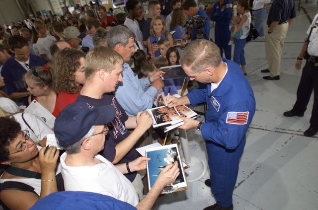 JSC2001-E-25824 (23 August 2001) --- Patrick G. Forrester, STS-105 mission specialist, signs autographs for the assembled crowd in Hangar 990 at Ellington Field during the STS-105 and Expedition Two crew return ceremonies.  The STS-105 crew delivered the Expedition Three crew and supplies to the International Space Station (ISS) and brought the Expedition Two crew back to Earth.