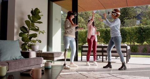 Diverse Women Enjoying Virtual Reality in Modern Living Space
