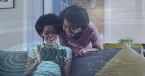 Mother and teenage daughter connecting over tablet with augmented reality overlay