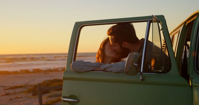 Couple enjoying a romantic moment inside a vintage van as the sun sets over a beautiful beach in the background. This image can be used for travel promotions, romantic getaways, beach vacation advertising, and lifestyle blogs focusing on travel and relationships.