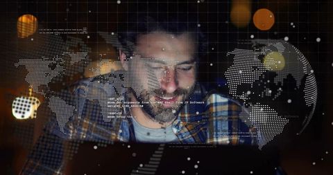 Bearded developer coding with global data visualization overlay on laptop for remote work