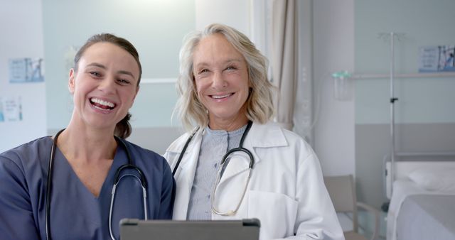 Smiling Female Medical Professionals Collaborating in Hospital Room - Download Free Stock Images Pikwizard.com