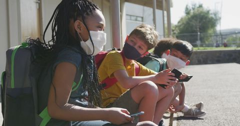 Happy Schoolchildren in Masks Socializing Outdoors During Pandemic - Download Free Stock Images Pikwizard.com