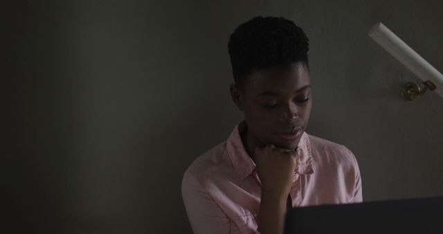 Thoughtful Woman Working on Laptop in Dimly Lit Room - Download Free Stock Images Pikwizard.com