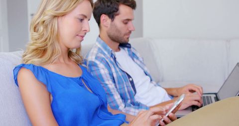 Couple Using Digital Devices on Home Sofa Relaxing - Download Free Stock Images Pikwizard.com