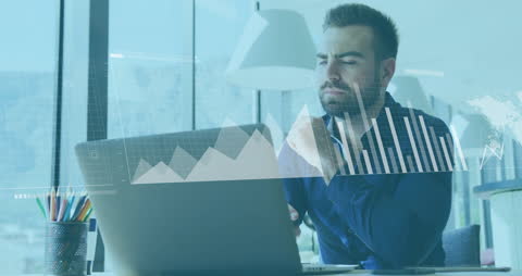 Focused Businessman Analyzing Data on Laptop with Graphs