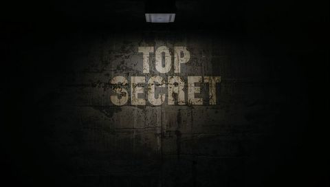 Top secret stencil on grungy concrete wall under overhead light, moody industrial noir