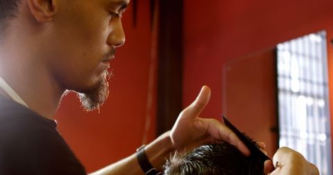 Asian Barber Focused on Precise Haircut in Barbershop - Download Free Stock Images Pikwizard.com