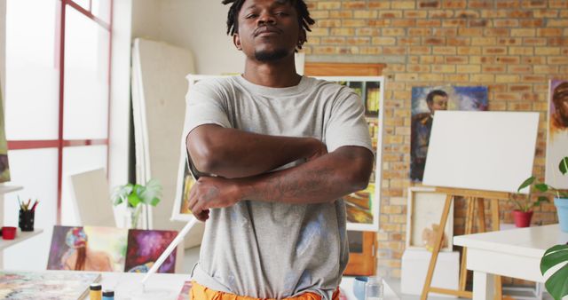 Portrait of african american male artist with arms crossed at art studio - Download Free Stock Photos Pikwizard.com