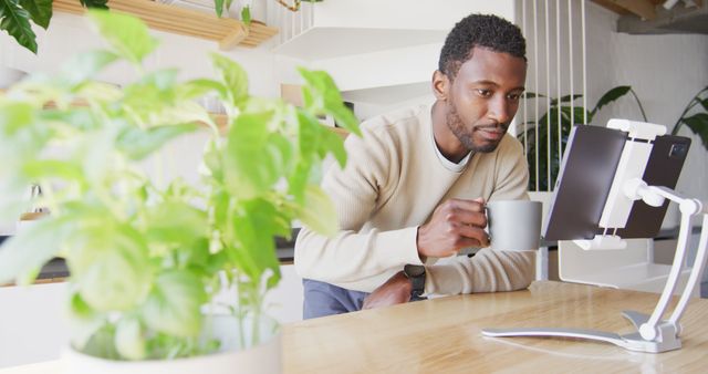 Focused Man Drinking Coffee While Working from Home - Download Free Stock Images Pikwizard.com