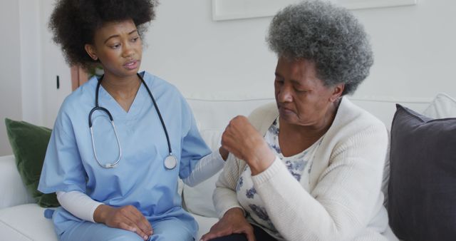 Caring african american female doctor and sad senior female talking. senior healthcare, support and lifestyle.