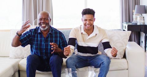 Father and Son Celebrating Sports Win on Home Sofa - Download Free Stock Images Pikwizard.com